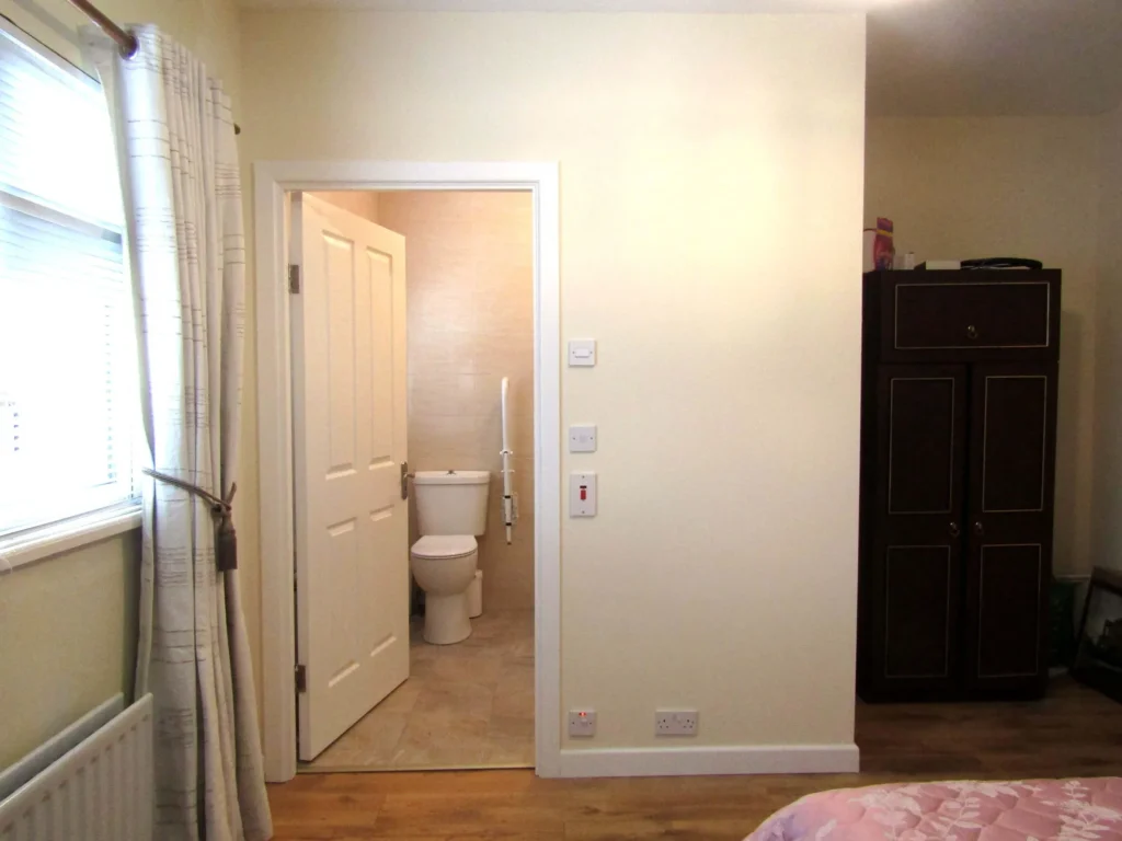 View of the accessible bathroom from the bed