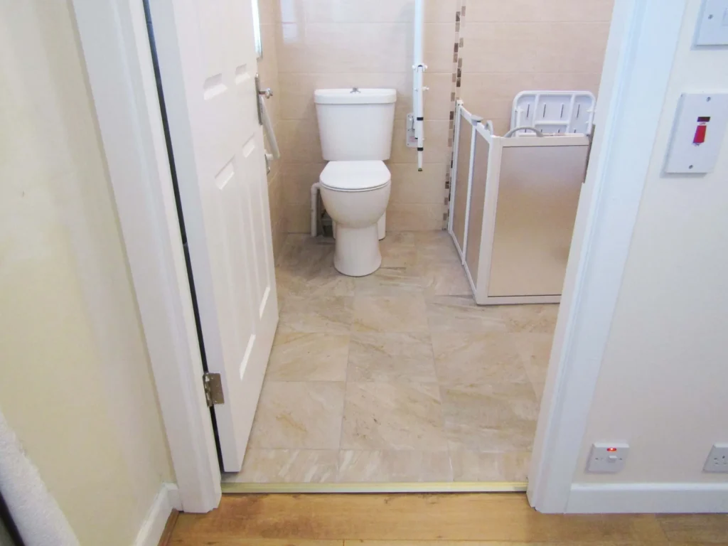 Level Access Shower beside toilet with grab rails