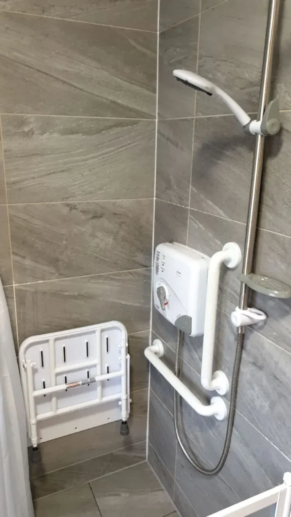 Level Access Shower with wall mounted shower seat and grab rail