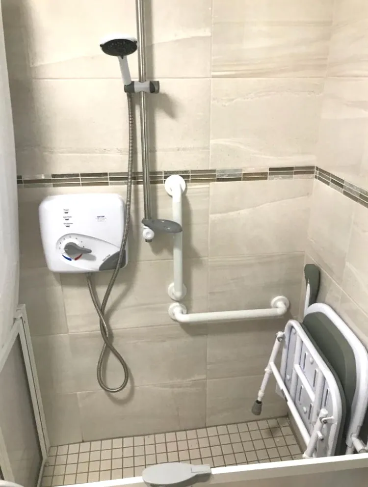 Level Access Shower with wall mounted shower seat and grab rail