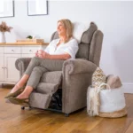 Smiling woman sitting on the Dorchester Riser Recliner