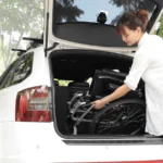 woman loading the Ergo 125 Self Propel Wheelchair at the back of car